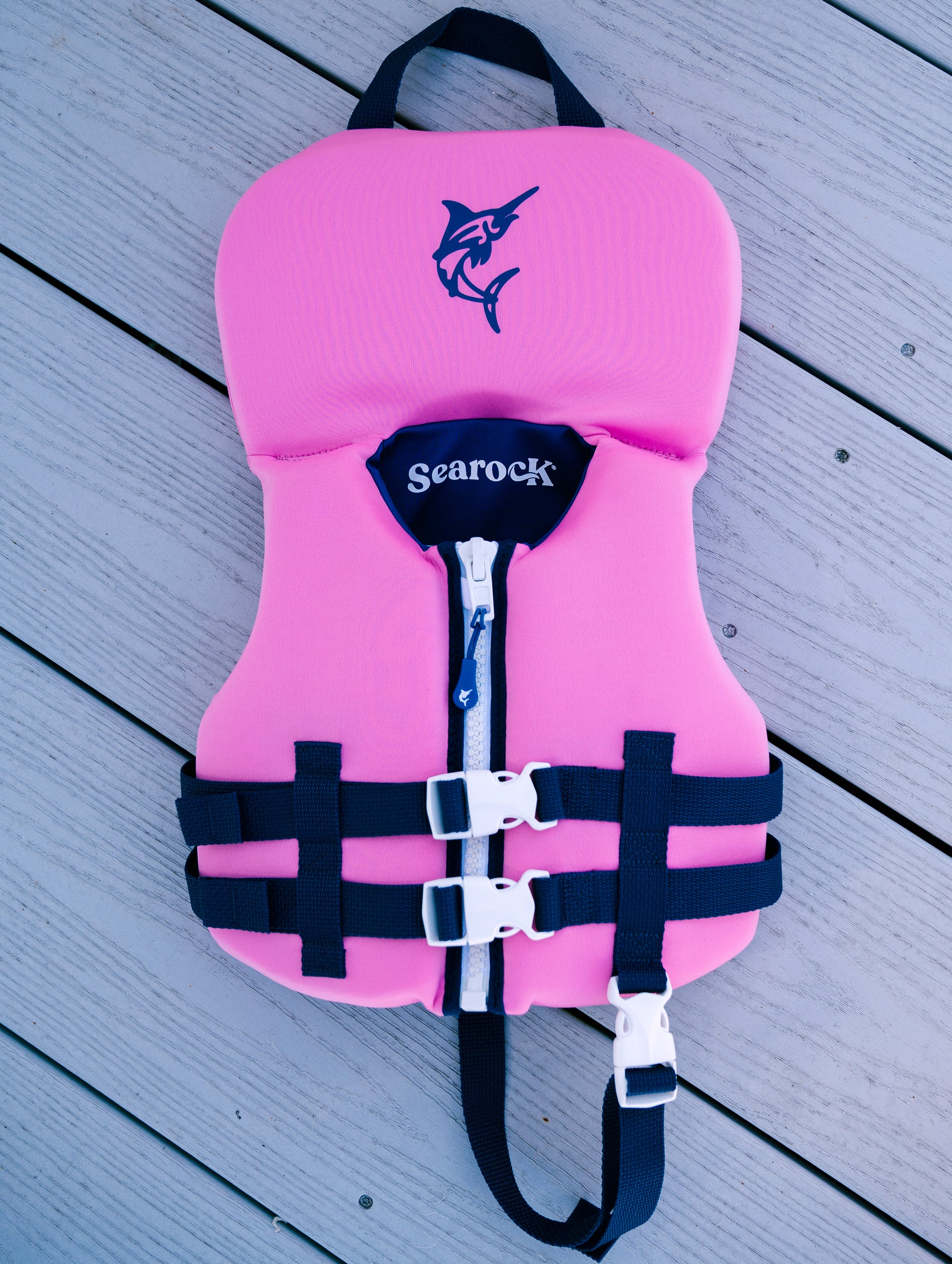 kids life jacket pink on dock